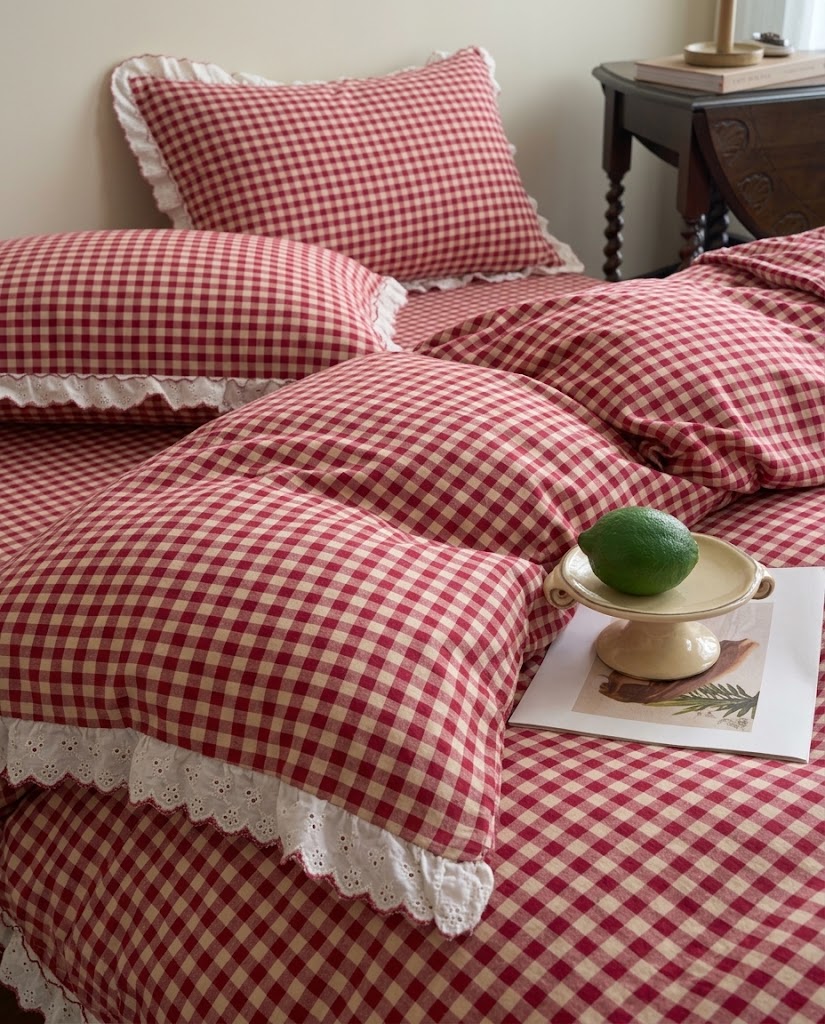 Gingham pillowcases with eyelet lace ruffles layered on a matching duvet cover