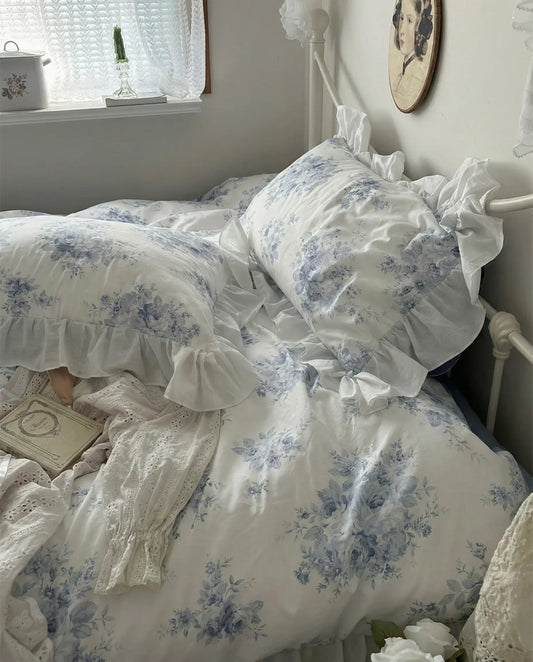 Layered blue floral bedding with romantic ruffles and vintage inspired bedroom decor