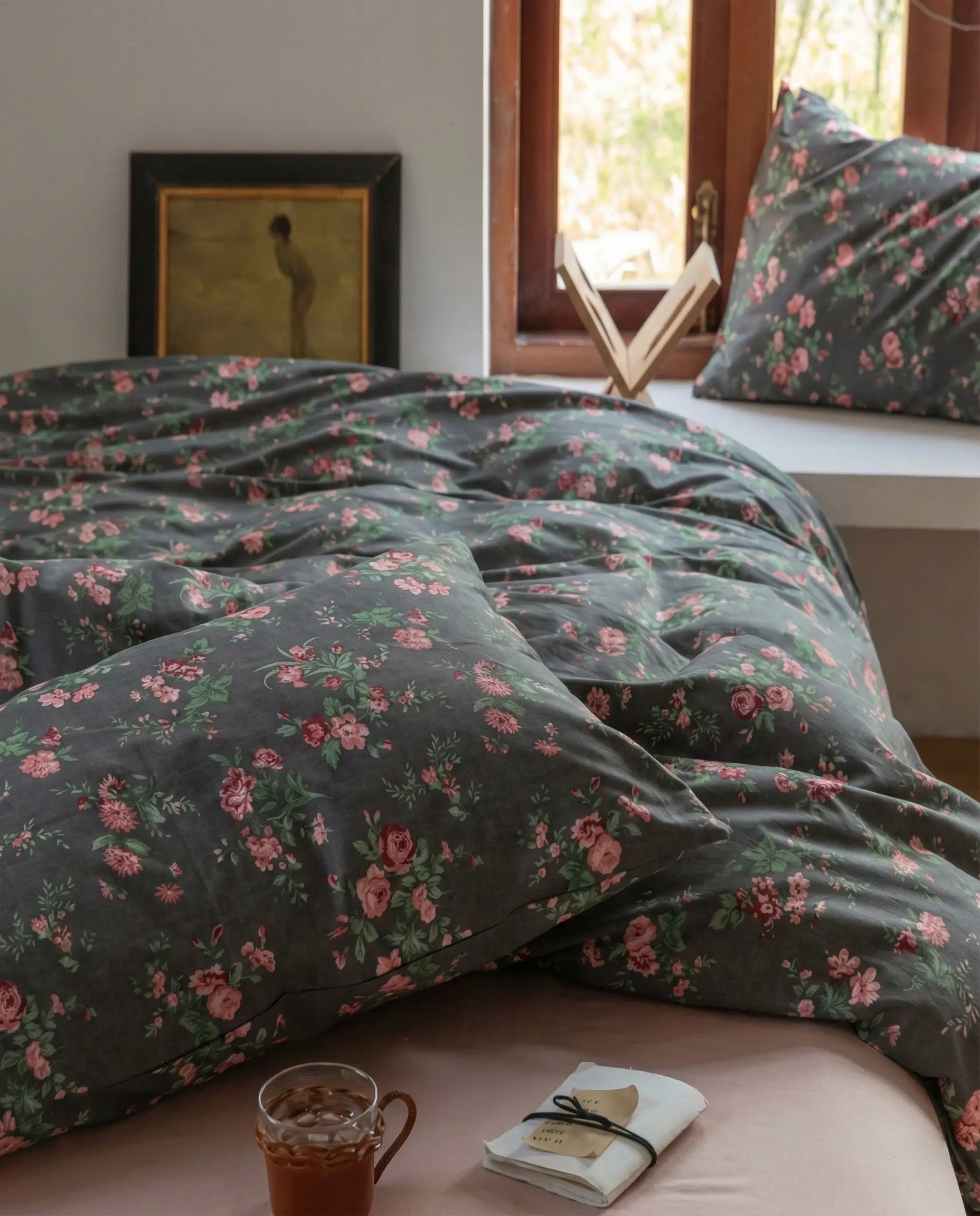 Black floral bedding set in natural light bedroom with window, soft cotton duvet cover and matching pillowcases