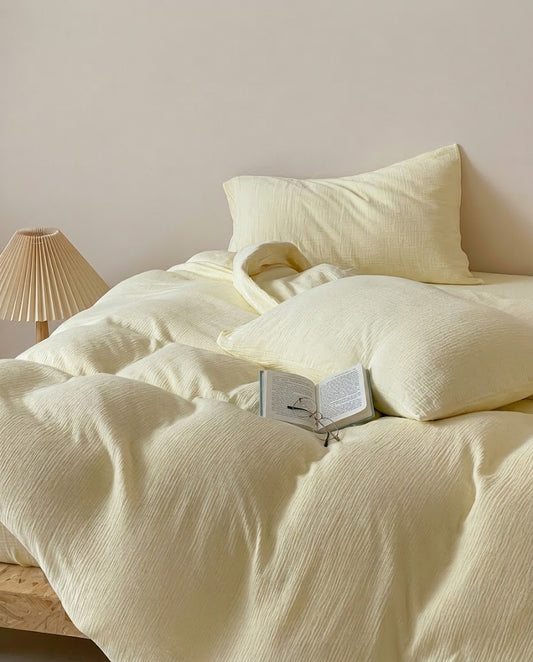 Butter muslin cotton double gauze duvet cover and pillowcases with a pleated lamp and reading glasses