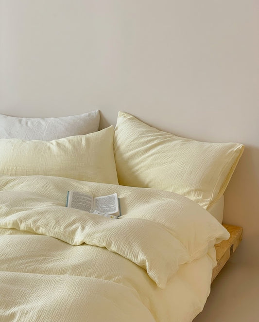 Relaxed Butter muslin cotton double gauze duvet cover and pillowcases with a grey accent pillow