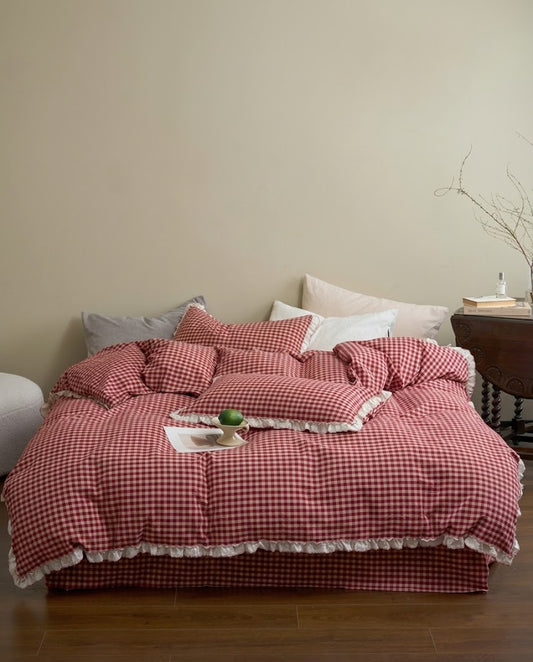 Cherry Gingham Ruffles Duvet Cover Set on a bed in a warm neutral bedroom with a wooden side table