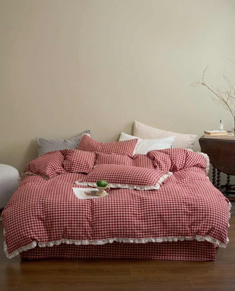 Cherry Gingham Ruffles Duvet Cover Set on a bed in a warm neutral bedroom with a wooden side table