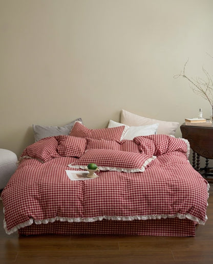 Cherry Gingham Ruffles Duvet Cover Set on a bed in a warm neutral bedroom with a wooden side table