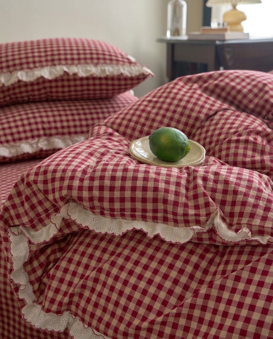 Rumpled washed cotton gingham duvet cover showing its eyelet ruffle edge