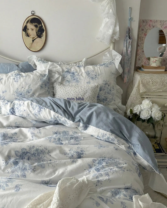 Close up of blue floral duvet cover fabric with delicate rose print and soft cotton texture
