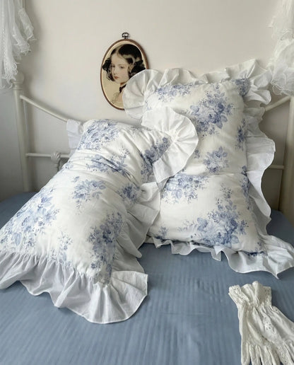 Vintage inspired blue floral bedding with ruffled pillow shams and soft layered styling