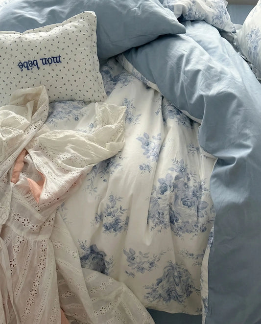 Blue floral duvet cover set paired with soft blue sheets in dreamy cottagecore bedroom