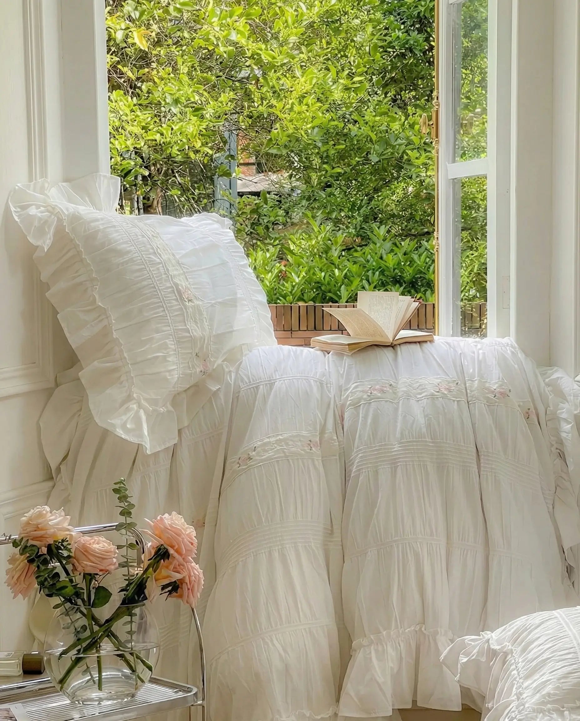 White ruched pillow shams and duvet cover showing gathered fabric texture and soft layered bedding