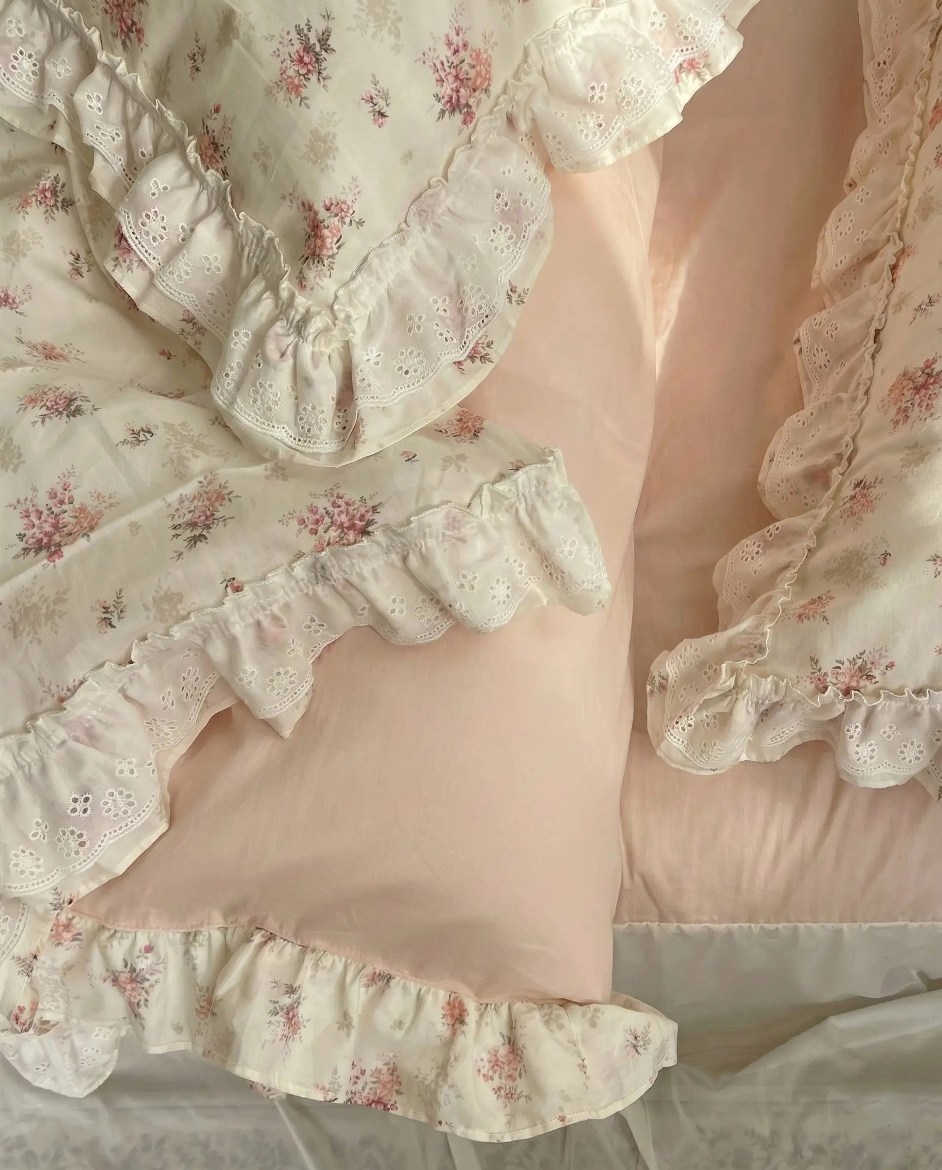 Shabby chic floral duvet cover with frill trim layered with blush bedding in soft aesthetic bedroom