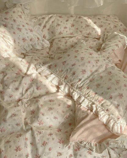 Cottage style floral duvet cover with soft blush sheets and romantic lace trim in bright bedroom