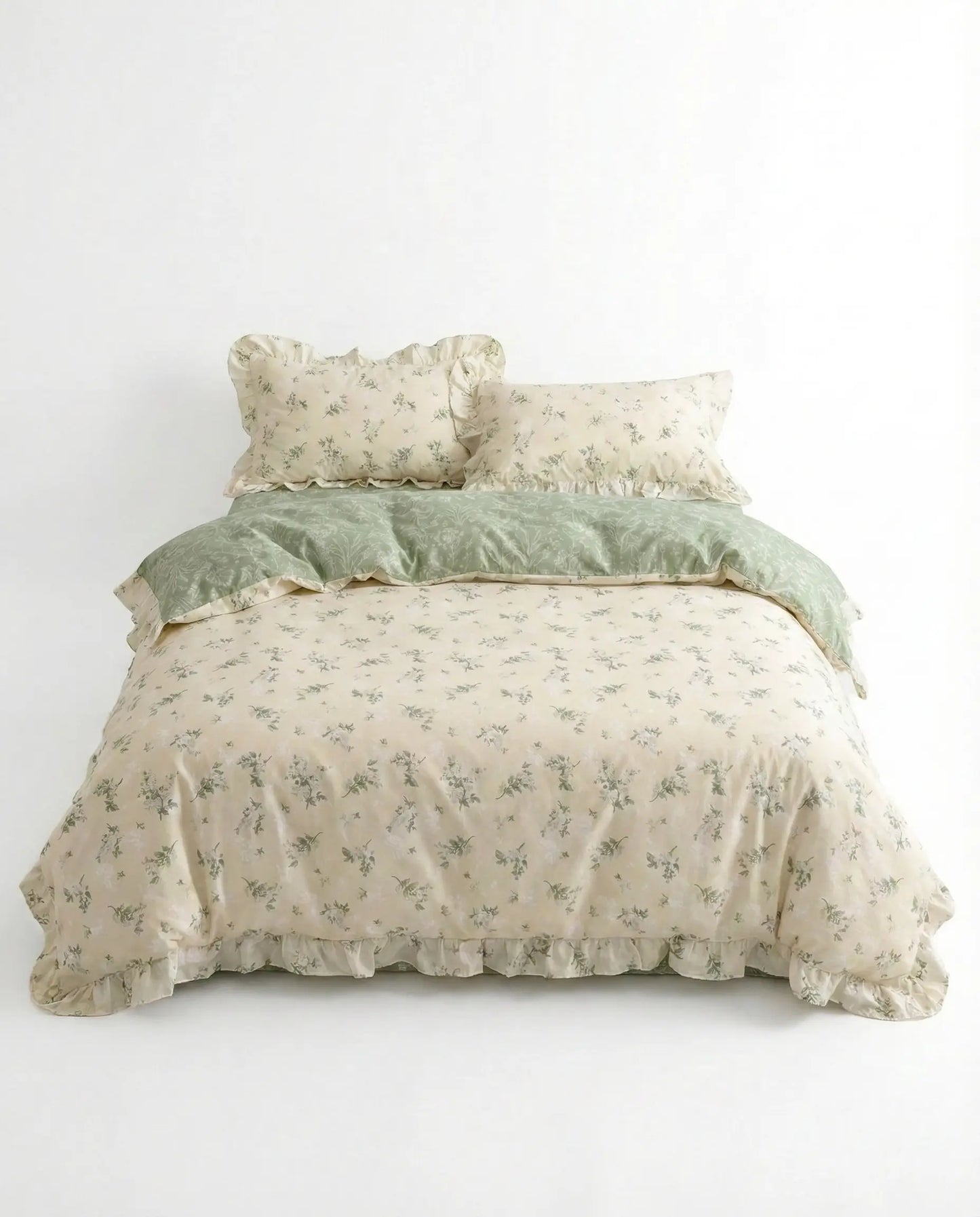 Studio image of floral bedding set with sage green botanical print and ruffled trim