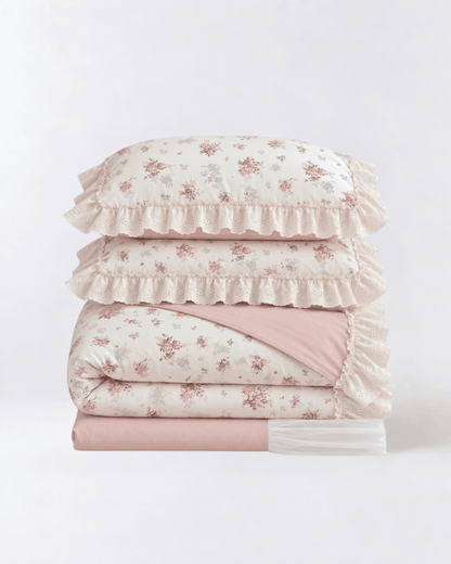 Floral duvet cover set with lace ruffle trim and blush pink sheets folded studio style product photo