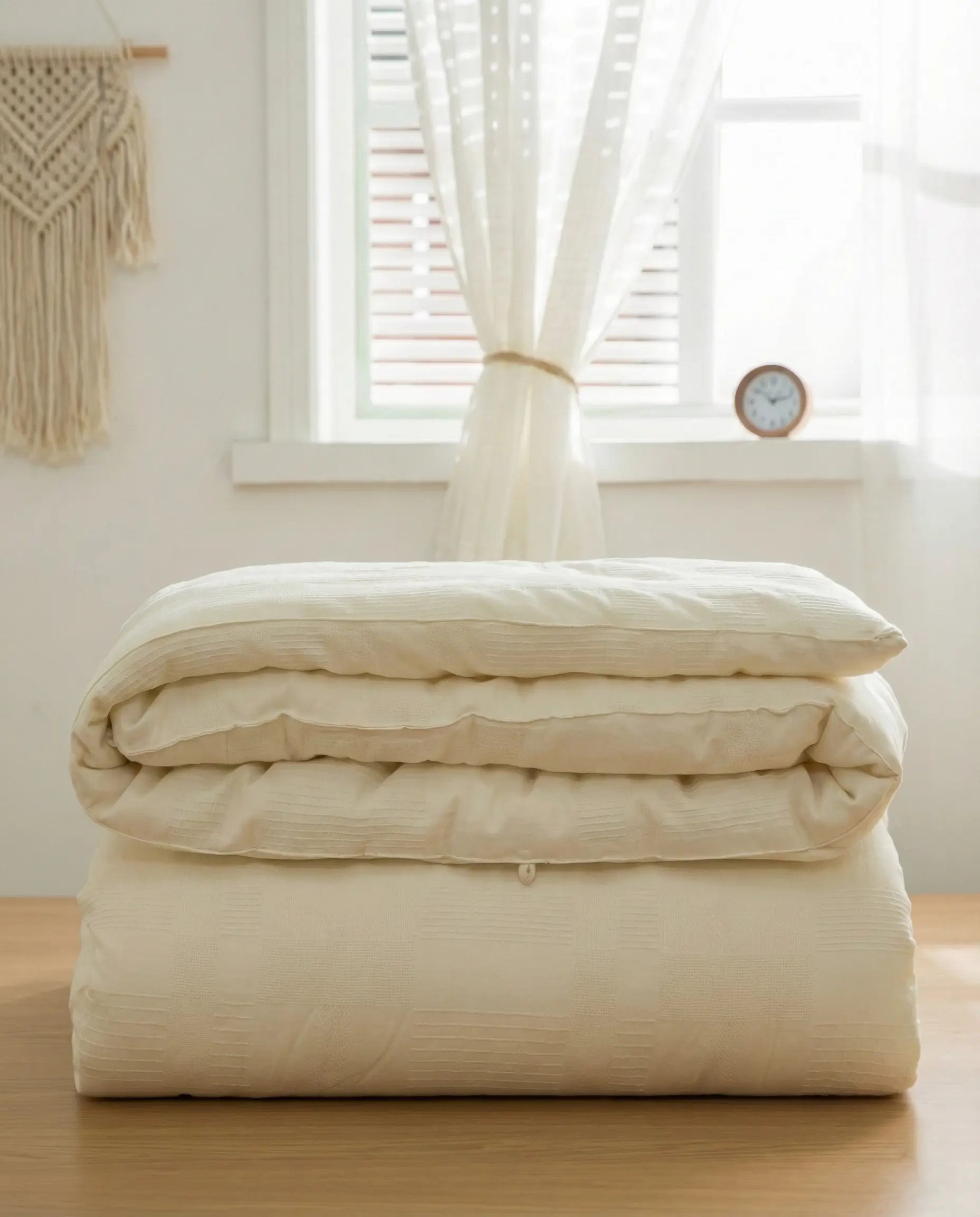 Folded organic soybean fiber duvet insert showing breathable cotton shell texture, hypoallergenic luxury duvet insert by DORMÉ Studio.