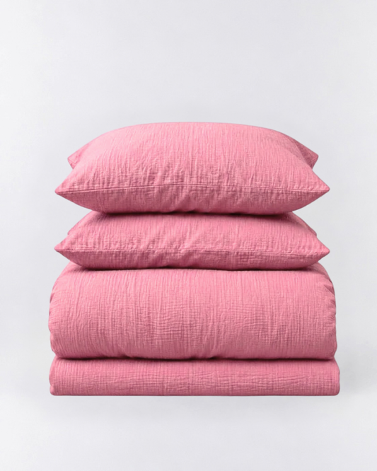 Amalfi Muslin Cotton Duvet Cover Set in Rose, folded duvet cover and two pillowcases on light grey