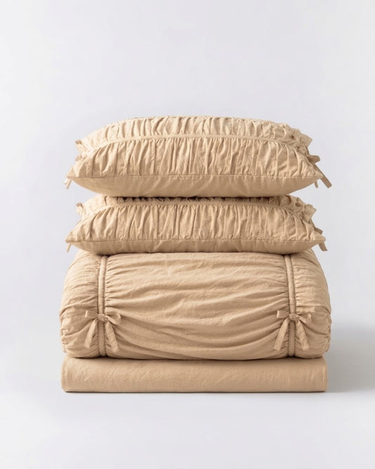 Folded Royal Ruched Duvet Cover Set in cream 100% washed cotton, stacked ruched pillowcases, bow-tied duvet cover and bed skirt