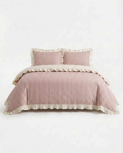 Front view of blush pink striped cotton duvet cover set with ivory ruffle trim and elegant minimalist bedding design