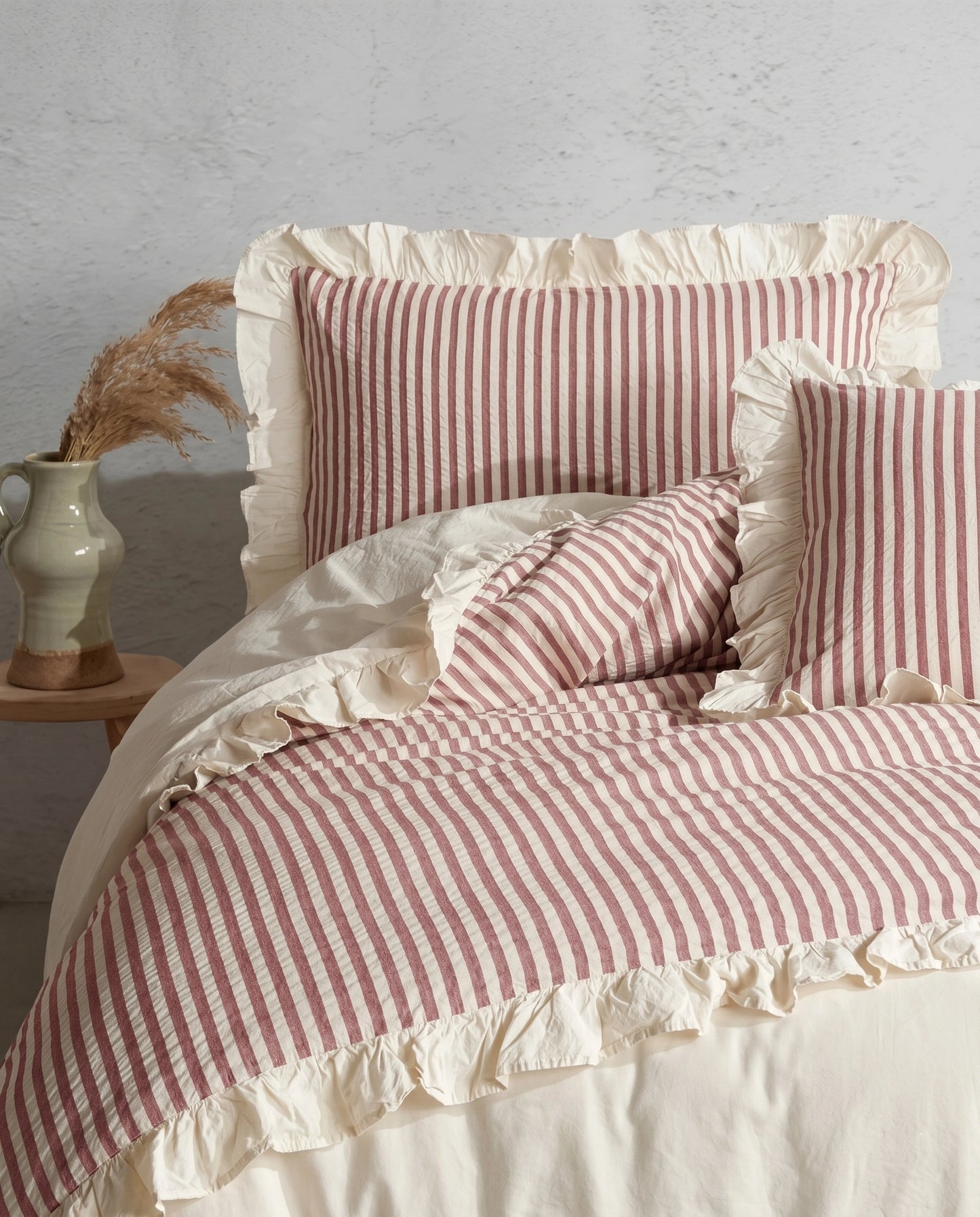 Blush pink and ivory striped cotton duvet cover set with romantic ruffle trim and soft ruched bedding details by DORMÉ Studio
