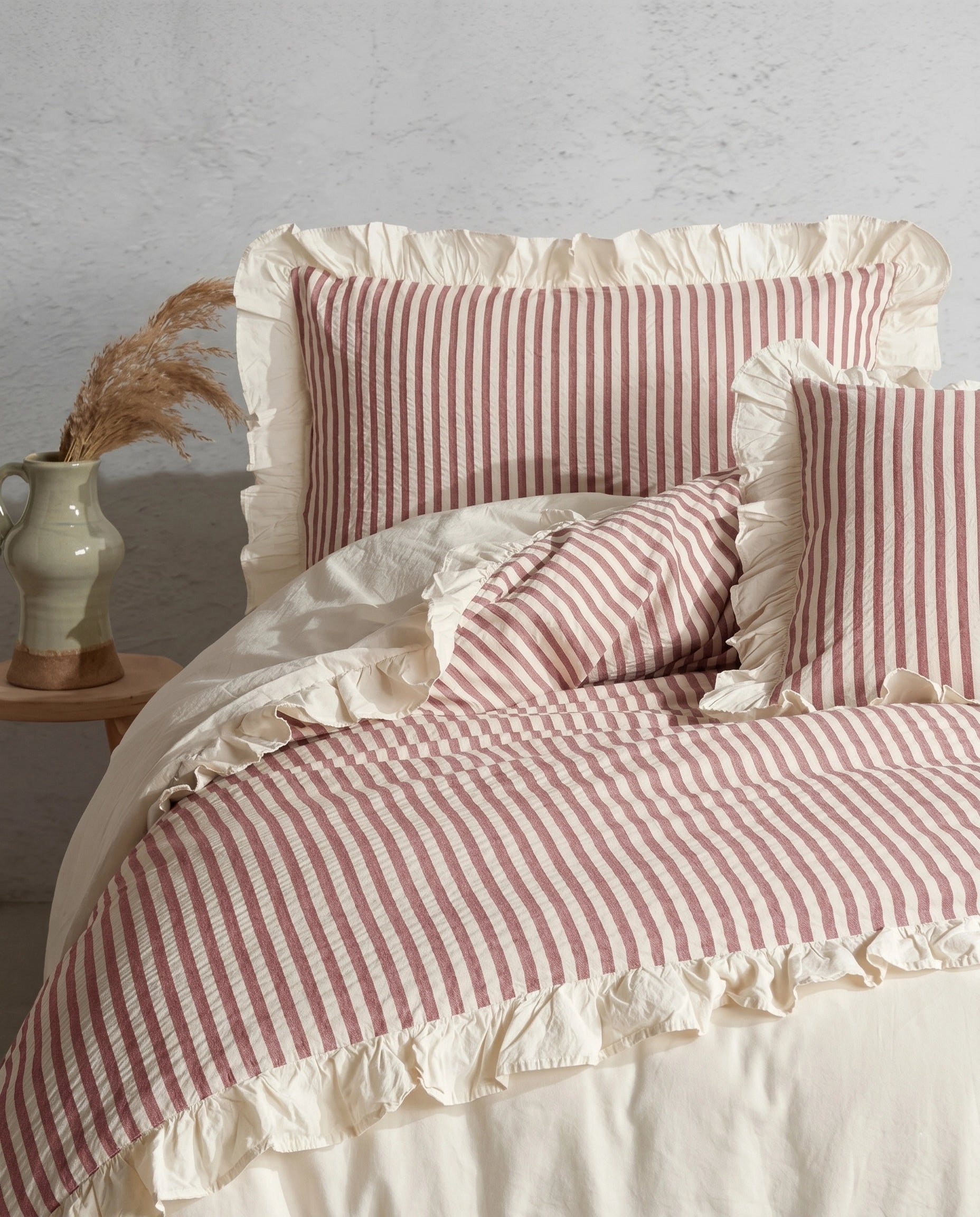 Blush pink and ivory striped cotton duvet cover set with romantic ruffle trim and soft ruched bedding details by DORMÉ Studio