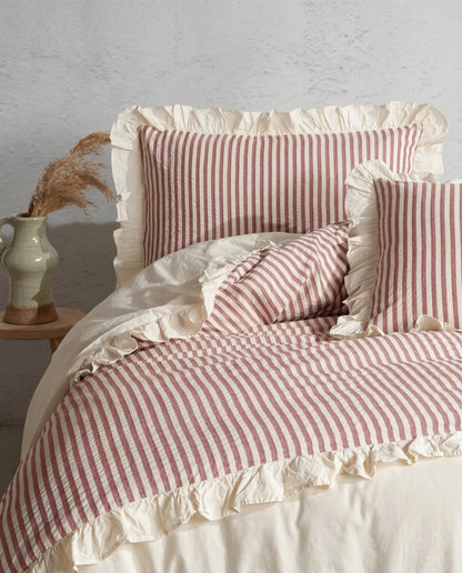Blush pink and ivory striped cotton duvet cover set with romantic ruffle trim and soft ruched bedding details by DORMÉ Studio