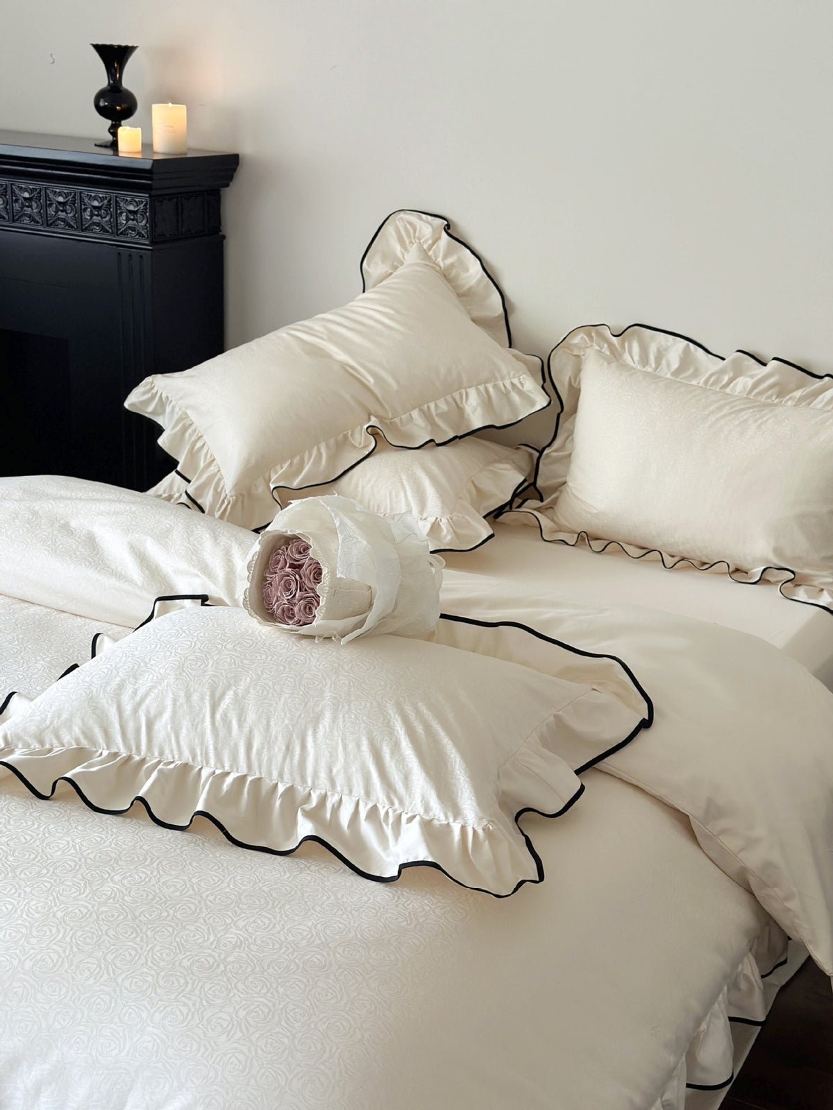 Camellia Ruffled Duvet Cover Set in Ivory with ruffled pillow shams and black trim in a styled bedroom