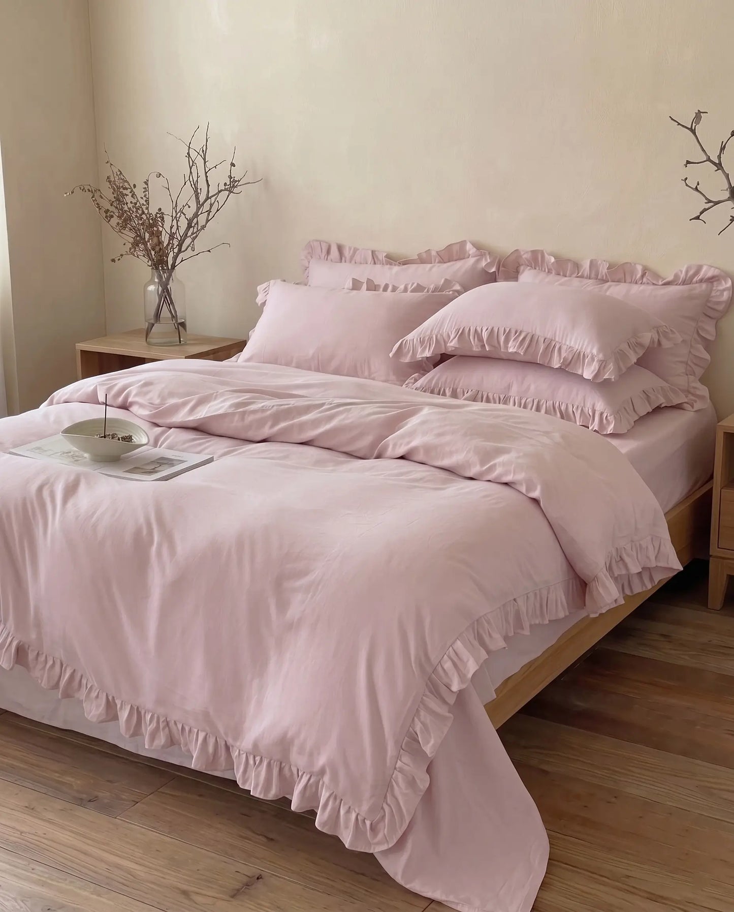 Luxury blush pink duvet cover set with elegant ruffle trim styled in a warm neutral bedroom aesthetic by DORMÉ Studio