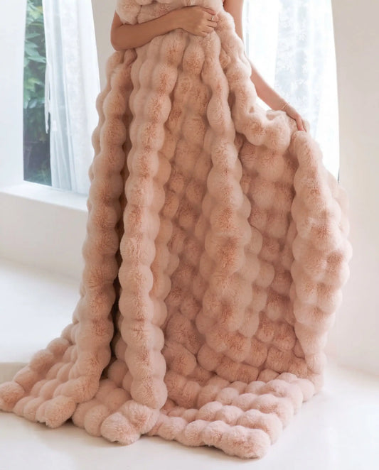 DORMÉ Studio Marshmallow Ultra Plush Blanket pink plush fabric draped vertically showing sculpted cloud like texture. Blossom