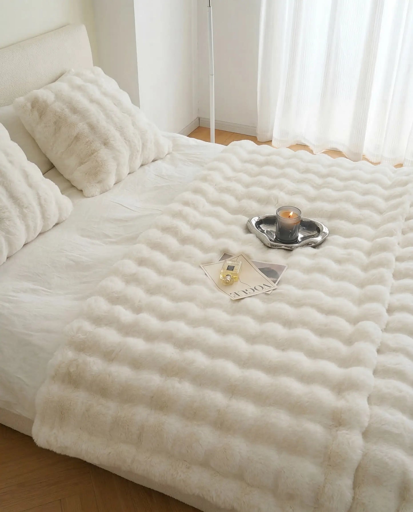 Minimal bedroom styled with DORMÉ Studio Marshmallow Ultra Plush Blanket featuring sculpted plush texture and neutral decor.