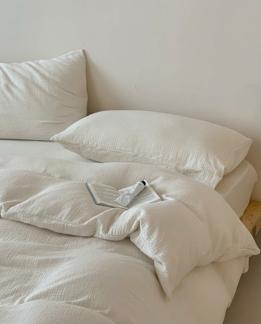 Close-up of a Pearl muslin cotton double gauze duvet cover showing the soft crinkled texture