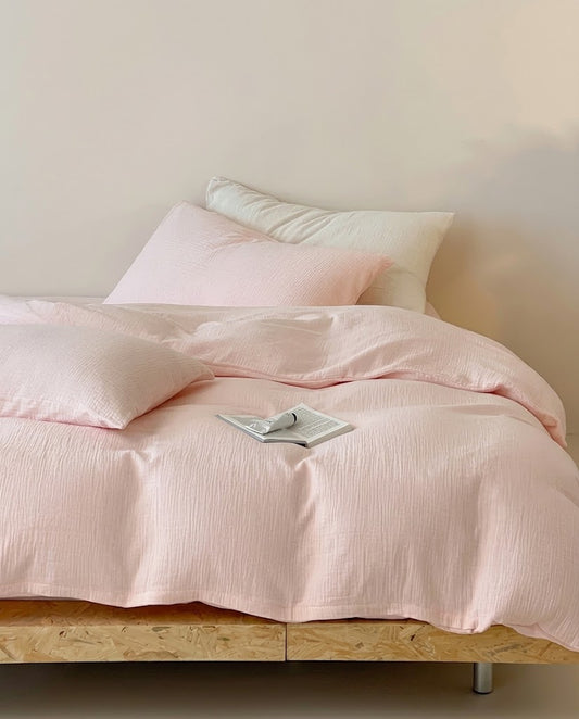 Petal muslin cotton double gauze duvet cover set on a low wooden platform bed