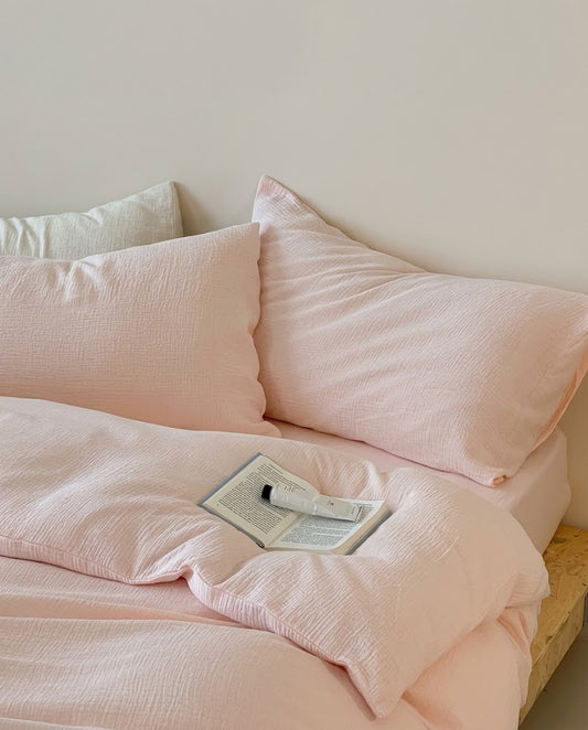 Relaxed Petal muslin cotton double gauze duvet cover and pillowcases with an open book