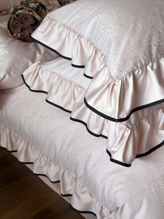 Close-up of black piped ruffles on the Camelia Ruffled Duvet Cover Set in Quartz cotton sateen