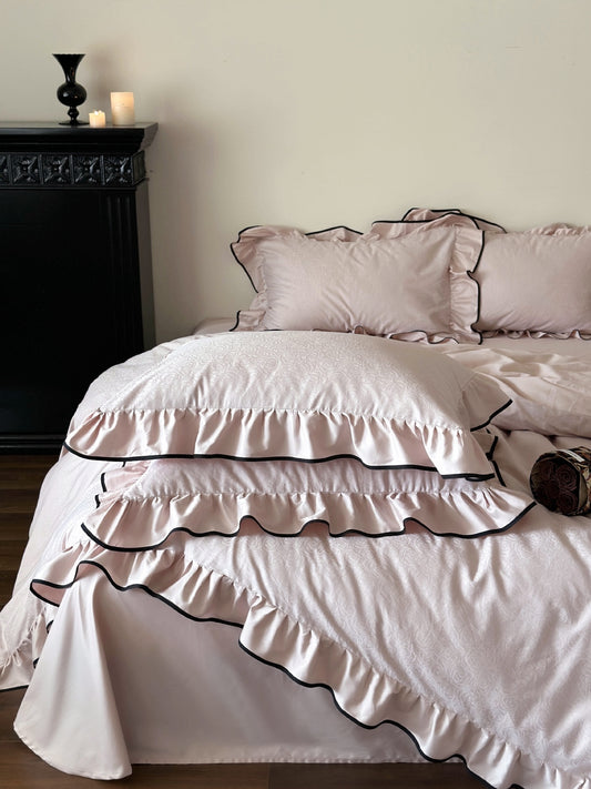 Camelia Ruffled Duvet Cover Set in Quartz with layered ruffles, black piping and rose jacquard pattern