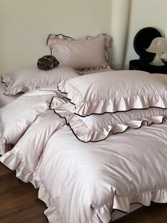 Quartz pink rose jacquard pillow shams with black piped ruffles from the Camellia Ruffled Duvet Cover Set