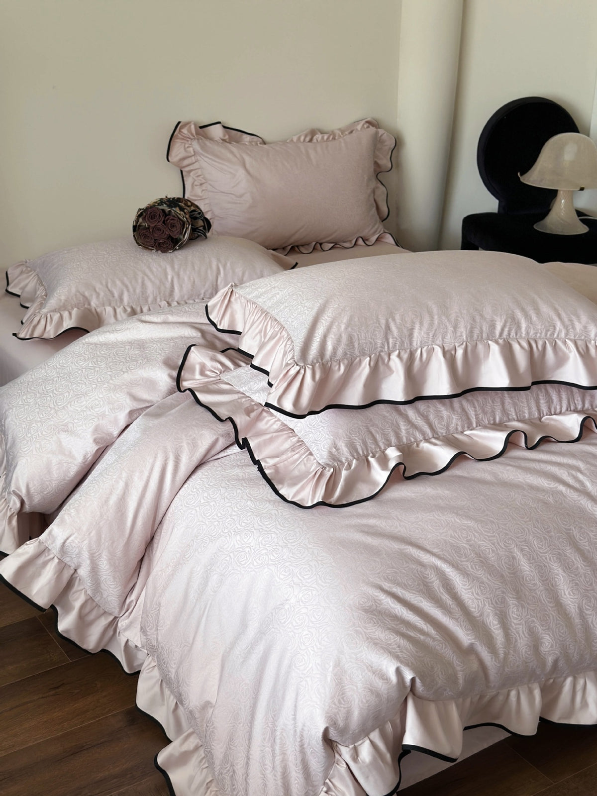 Quartz pink rose jacquard pillow shams with black piped ruffles from the Camellia Ruffled Duvet Cover Set