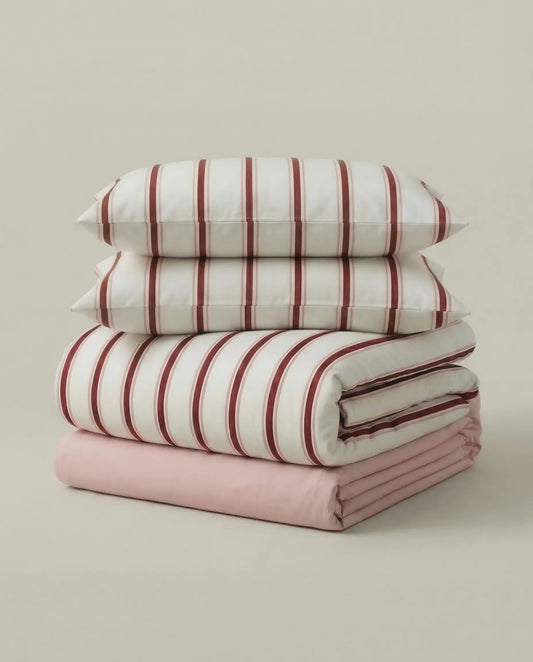 Folded red stripe cotton duvet cover set with pillowcases and pink sheet, minimalist striped bedding by DORMÉ Studio