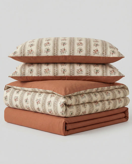 Retro terracotta floral duvet cover set folded with pillowcases and sheet, vintage striped botanical cotton bedding