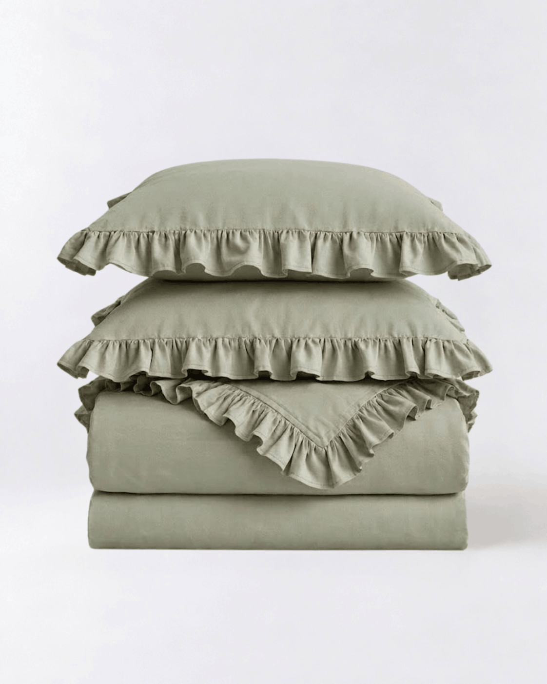 Folded eucalyptus sage ruffle bedding set showcasing soft washed cotton fabric and elegant layered ruffle detailing by DORMÉ Studio