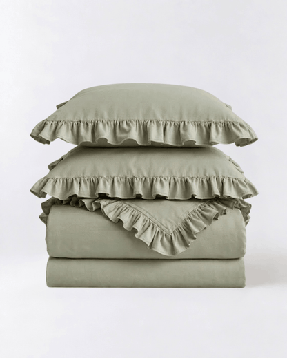 Folded eucalyptus sage ruffle bedding set showcasing soft washed cotton fabric and elegant layered ruffle detailing by DORMÉ Studio