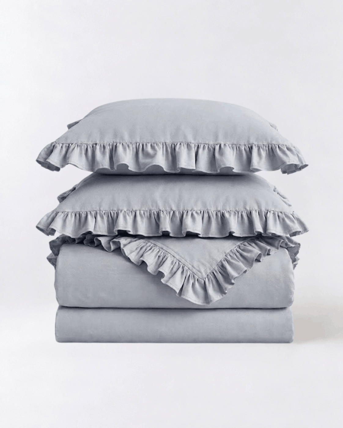 Folded mist blue ruffle bedding set showcasing soft washed cotton texture and elegant layered trim by DORMÉ Studio