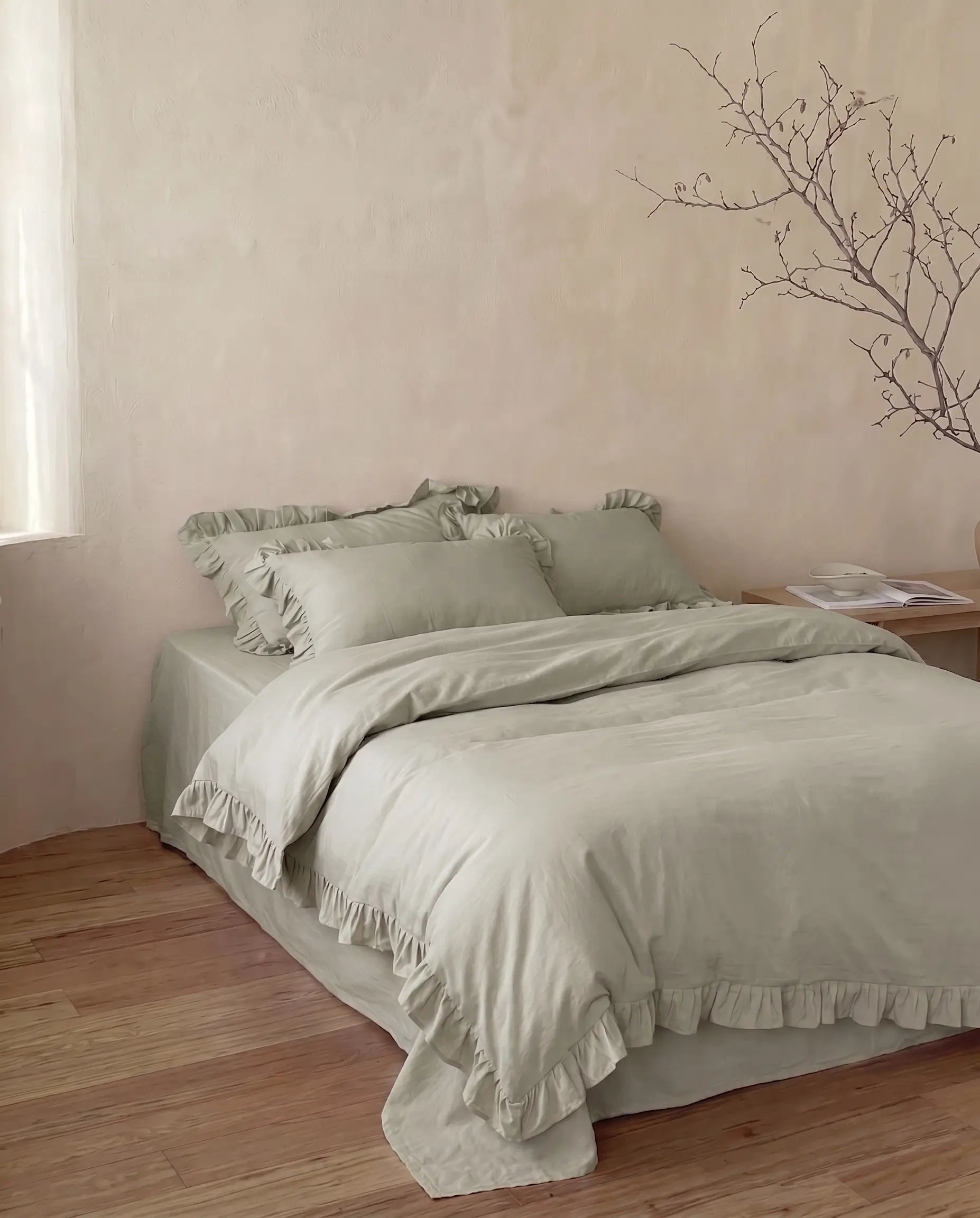 Sage green ruffle duvet cover set with soft feminine styling and elegant neutral bedroom decor by DORMÉ Studio
