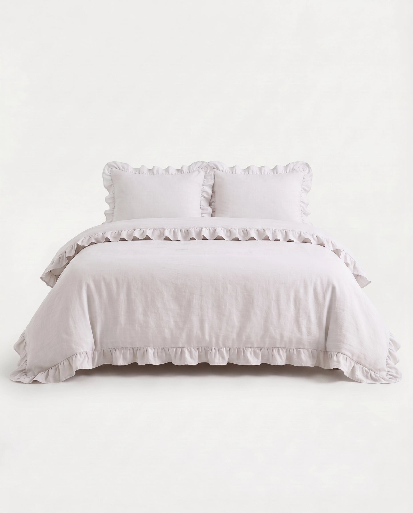 Front-facing studio image of the Rosalie snow white ruffle duvet cover set with matching pillowcases and romantic trim details