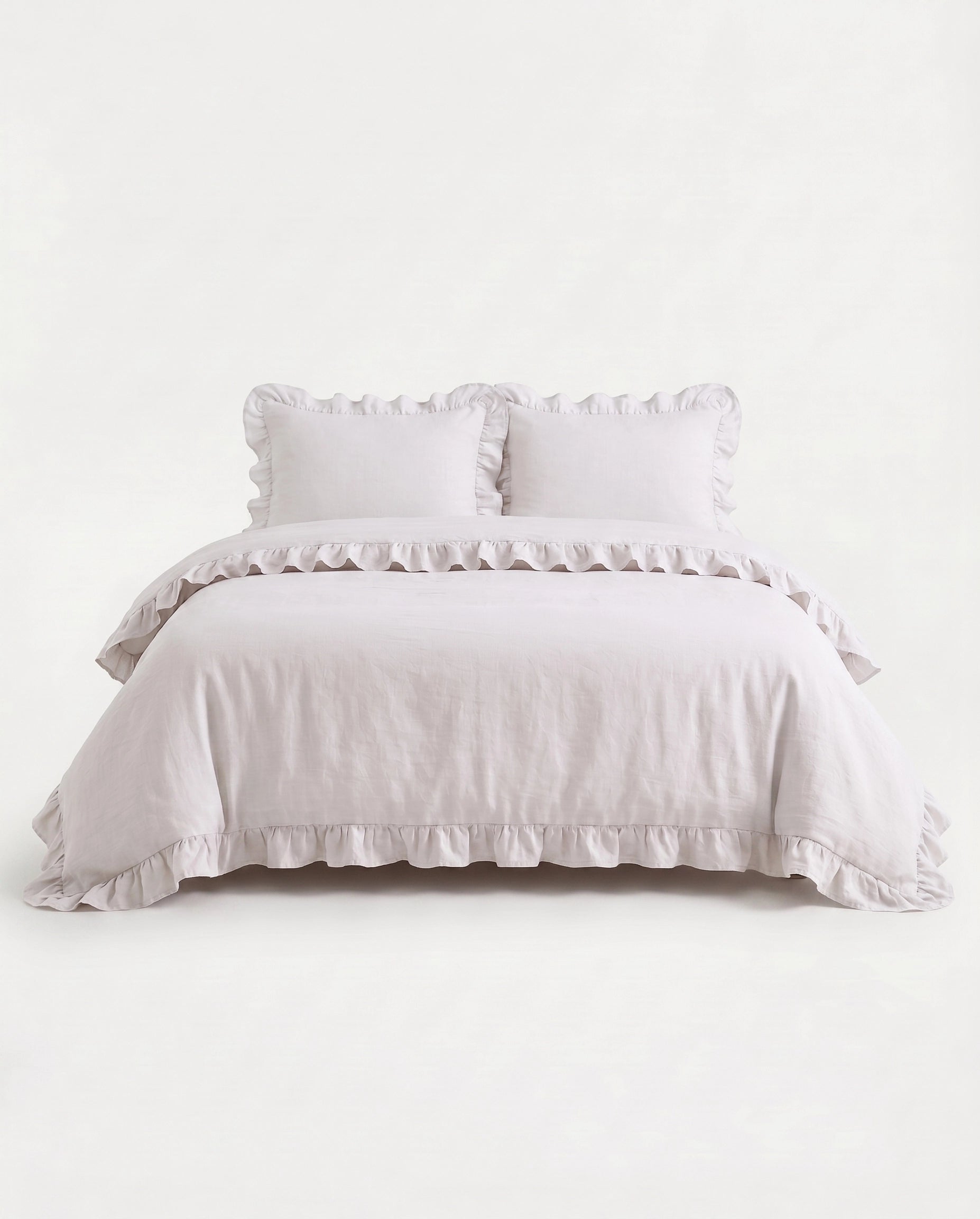 Front-facing studio image of the Rosalie snow white ruffle duvet cover set with matching pillowcases and romantic trim details