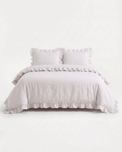 Front-facing studio image of the Rosalie snow white ruffle duvet cover set with matching pillowcases and romantic trim details