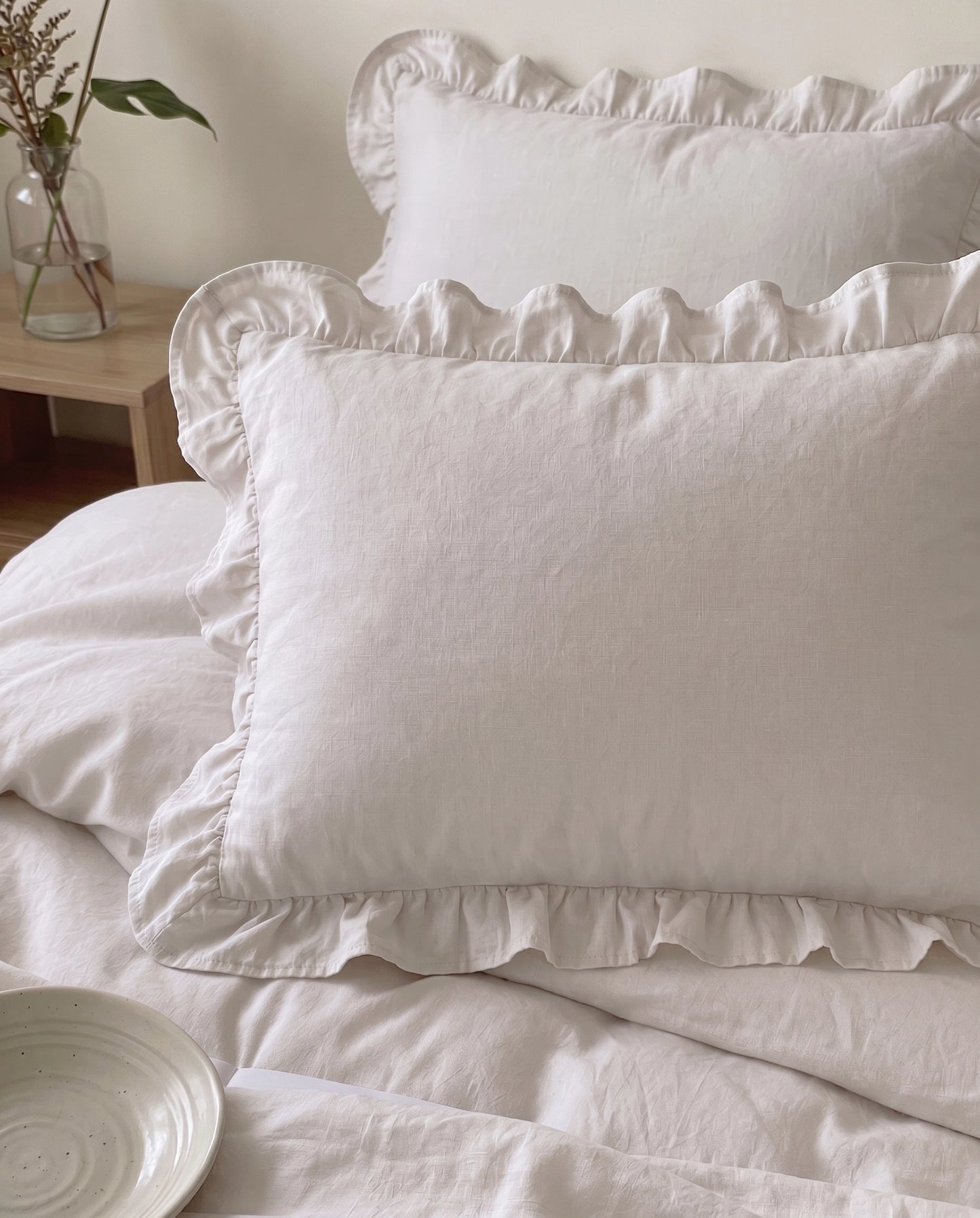 Snow white ruffle pillow sham close-up featuring soft luxury cotton texture and elegant feminine bedding styling by DORMÉ Studio