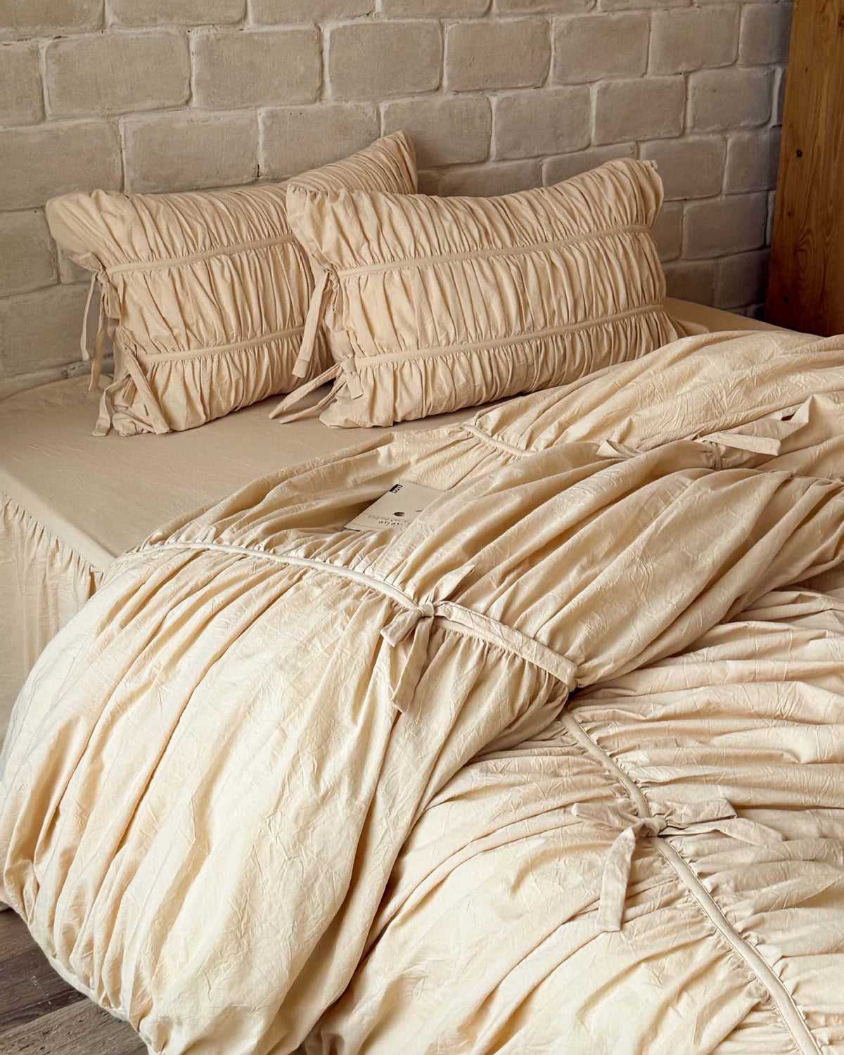Royal Ruched Duvet Cover Set in cream washed cotton, two ruched pillowcases with tie closures and a bow-tied duvet cover