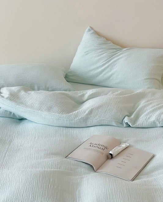 Close-up of Seafoam muslin cotton double gauze bedding showing the soft crinkled texture