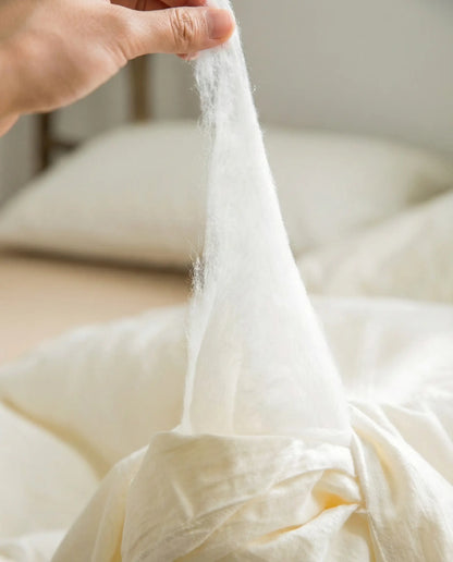 Close up showing soft soybean fiber fill inside organic duvet insert, breathable plant based alternative to down by DORMÉ Studio.