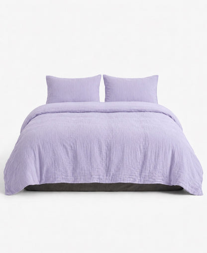 Lilac muslin cotton double gauze duvet cover set with two pillow shams, front view on white