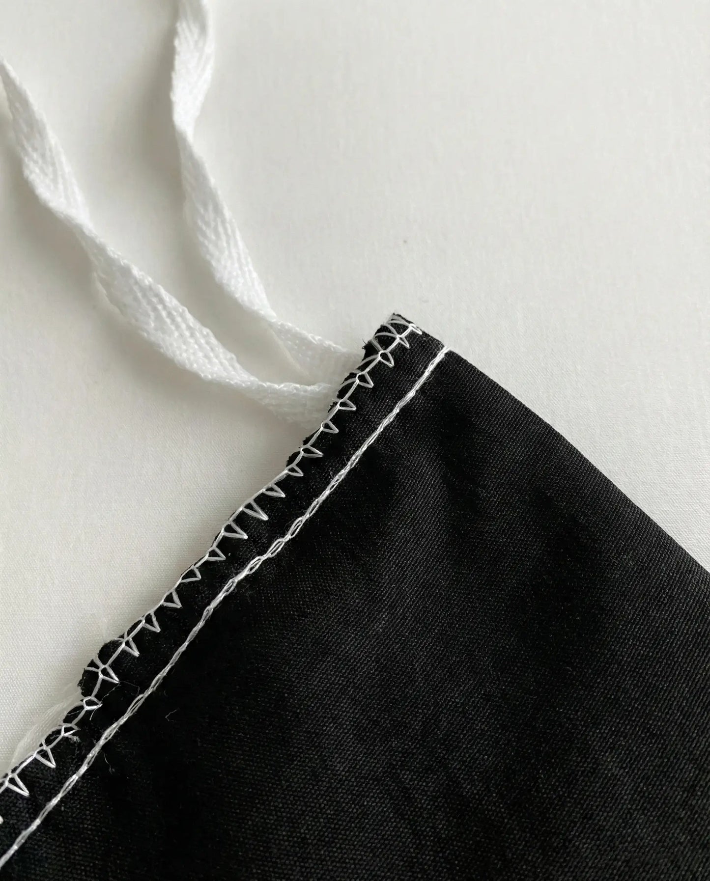Interior corner tie detail on black duvet cover designed to secure duvet insert in place